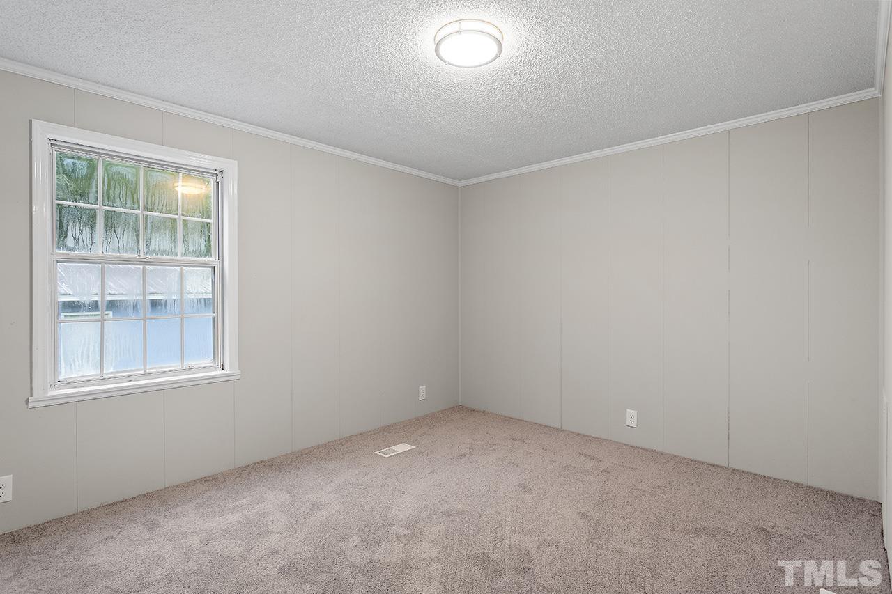 1002 Autry Road Lillington, NC 27546 - Photo 20 of 38 an empty room with a window