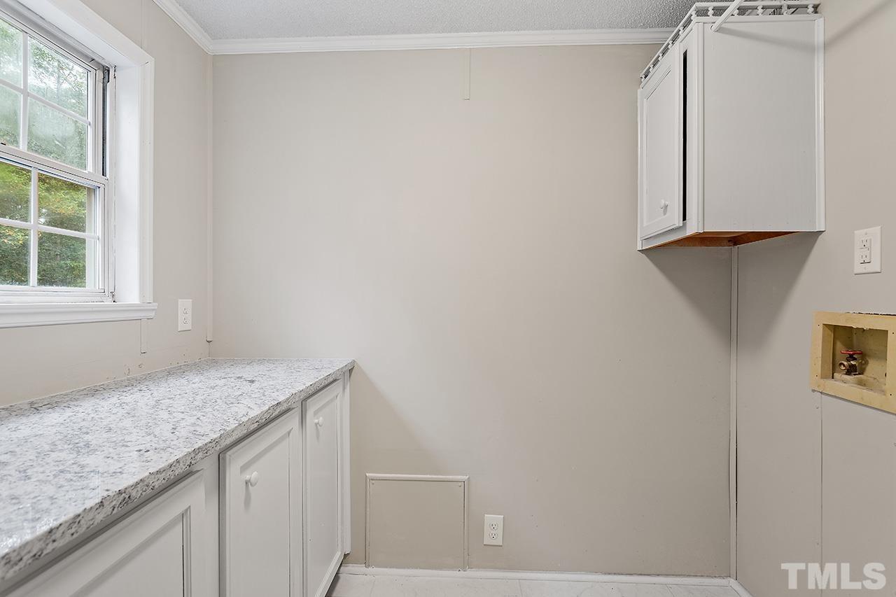 1002 Autry Road Lillington, NC 27546 - Photo 23 of 38 a bathroom with a granite countertop sink and a vanity
