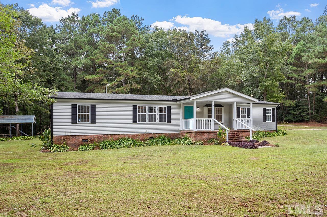 1002 Autry Road Lillington, NC 27546 - Photo 24 of 38 a front view of a house with garden