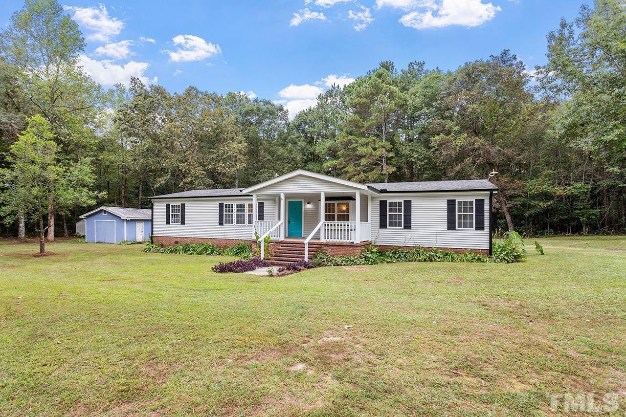 1002 Autry Road Lillington, NC 27546 - Photo 25 of 38 a front view of a house with a garden