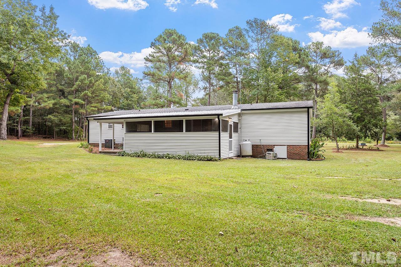 1002 Autry Road Lillington, NC 27546 - Photo 33 of 38 a front view of house with yard and trees