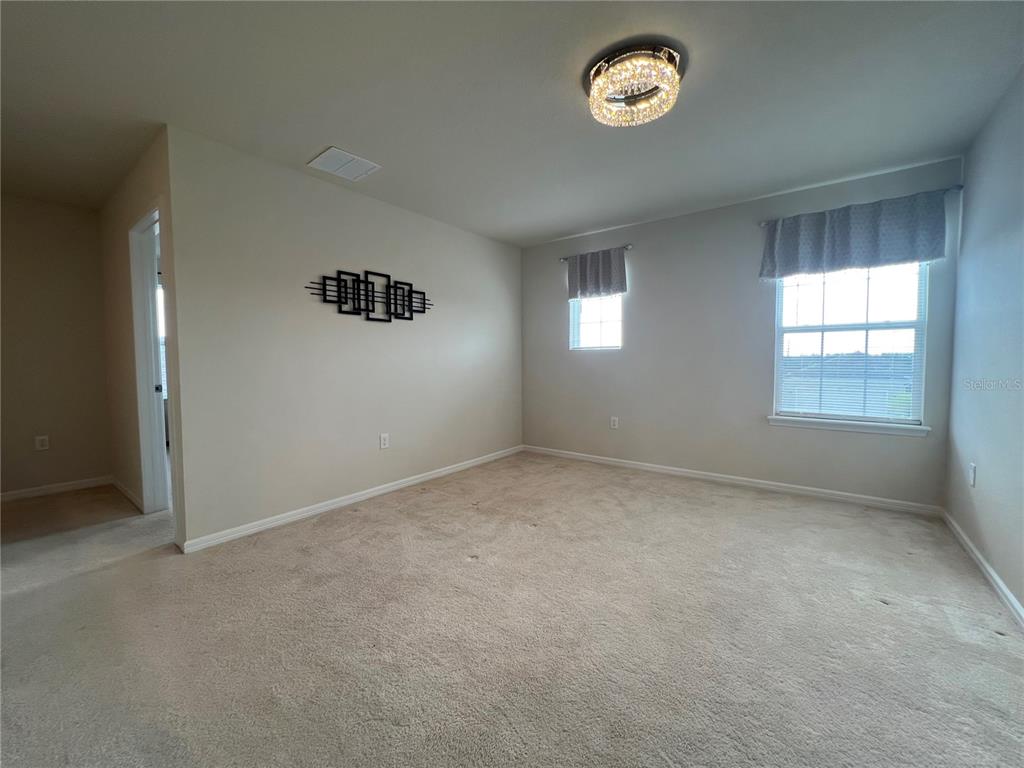 7488 Catania Loop Clermont, FL 34714 - Photo 11 of 22 an empty room with a window