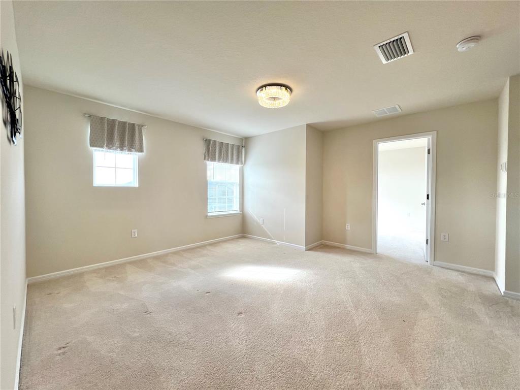 7488 Catania Loop Clermont, FL 34714 - Photo 12 of 31 a view of an empty room with a window