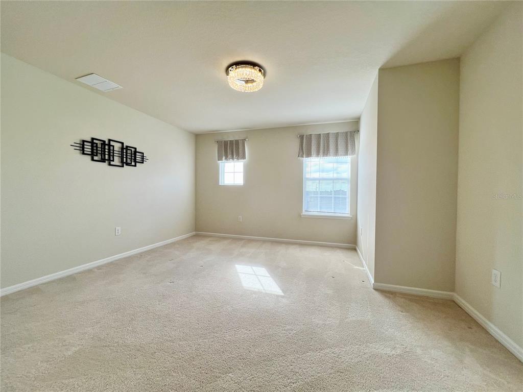 7488 Catania Loop Clermont, FL 34714 - Photo 13 of 31 an empty room with windows
