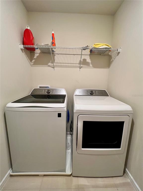 7488 Catania Loop Clermont, FL 34714 - Photo 14 of 22 a utility room with dryer and washer