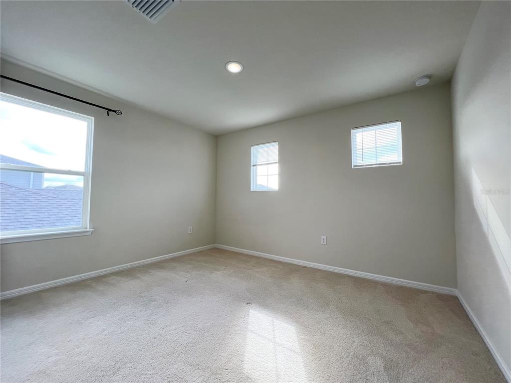 7488 Catania Loop Clermont, FL 34714 - Photo 17 of 31 an empty room with windows