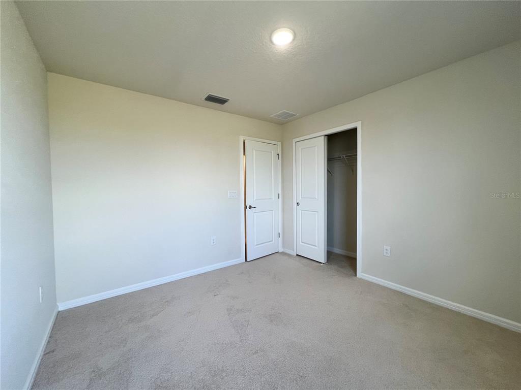 7488 Catania Loop Clermont, FL 34714 - Photo 19 of 31 an empty room with an entryway