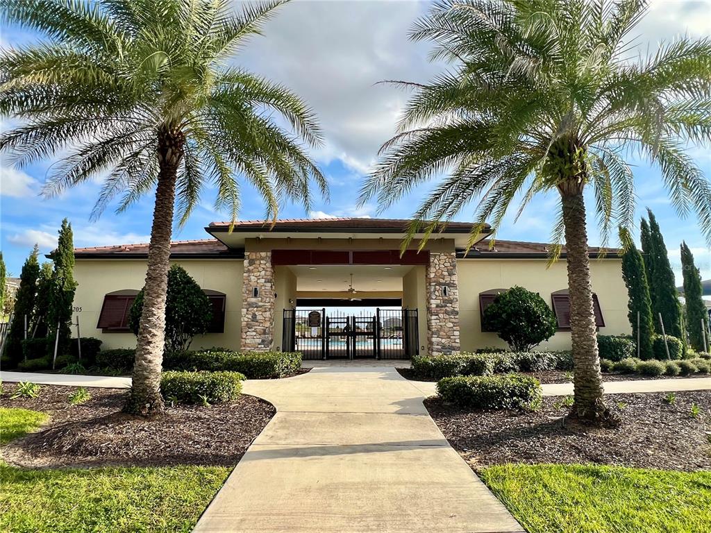 7488 Catania Loop Clermont, FL 34714 - Photo 19 of 22 a front view of a house with garden