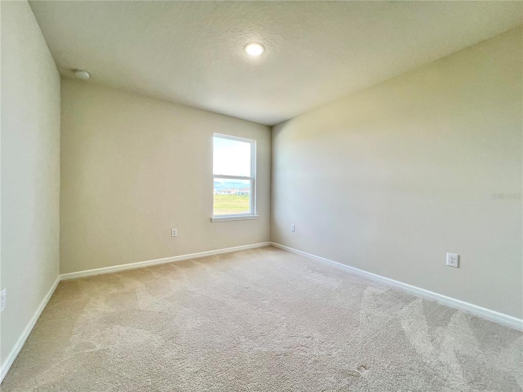 7488 Catania Loop Clermont, FL 34714 - Photo 20 of 31 an empty room with windows