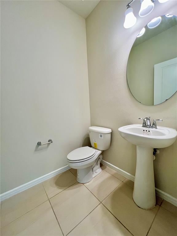 7488 Catania Loop Clermont, FL 34714 - Photo 21 of 31 a bathroom with a toilet sink and mirror