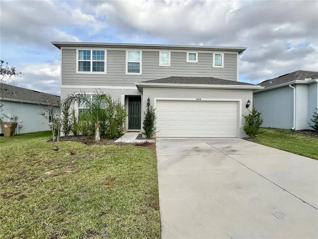 a front view of a house with a yard and garage
