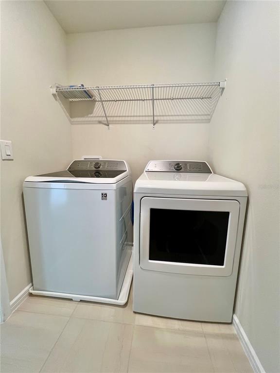 7488 Catania Loop Clermont, FL 34714 - Photo 22 of 31 a utility room with dryer and washer
