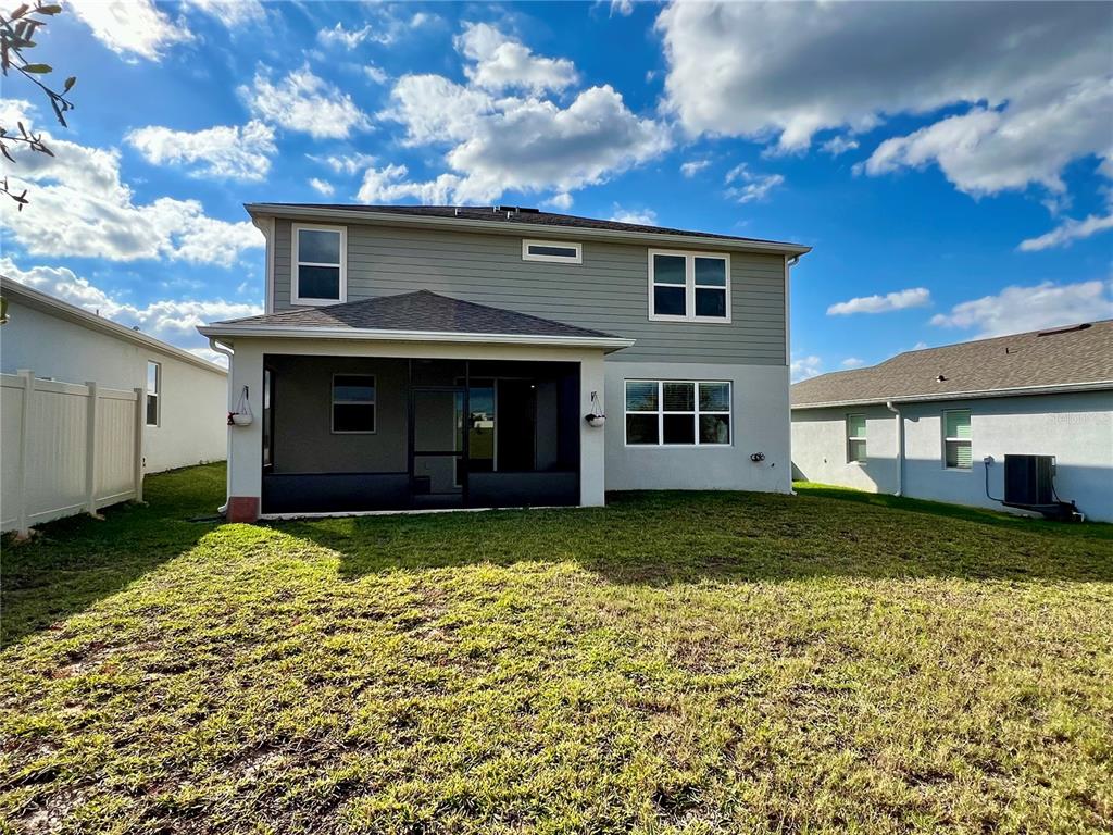 7488 Catania Loop Clermont, FL 34714 - Photo 25 of 31 a view of a house with a yard