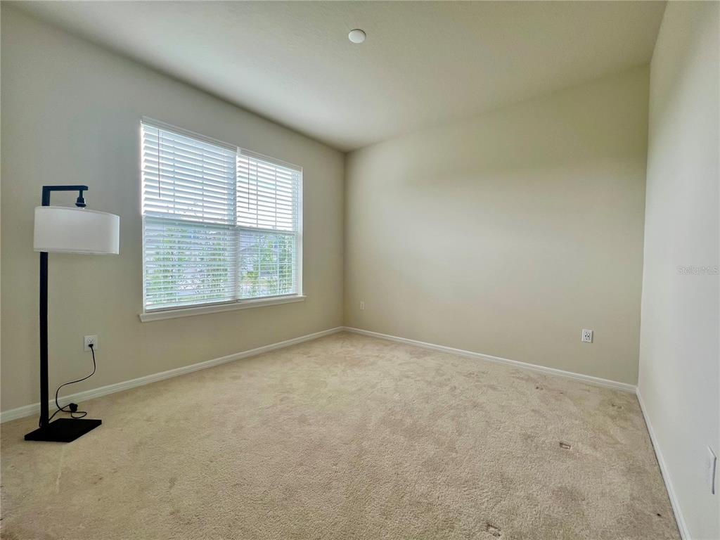 7488 Catania Loop Clermont, FL 34714 - Photo 3 of 22 an empty room with windows