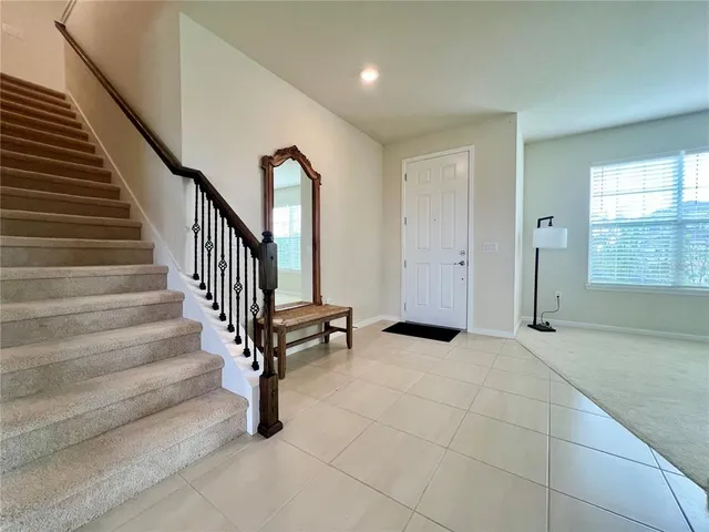 a view of an entryway with wooden floor and windows