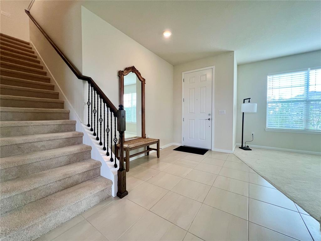 7488 Catania Loop Clermont, FL 34714 - Photo 4 of 22 a view of an entryway with wooden floor and windows