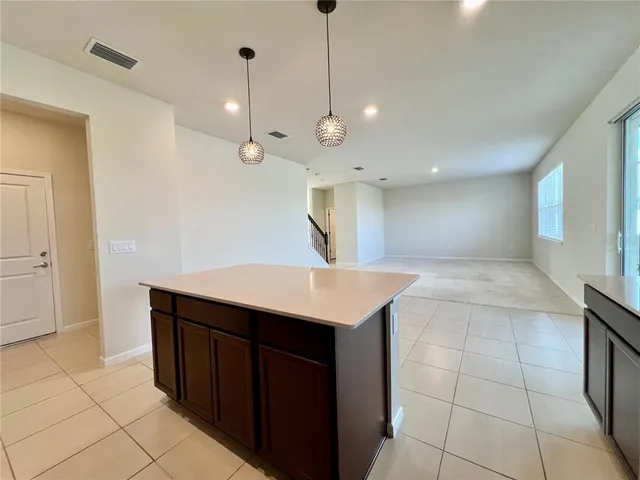 a kitchen with a sink a counter space and cabinets