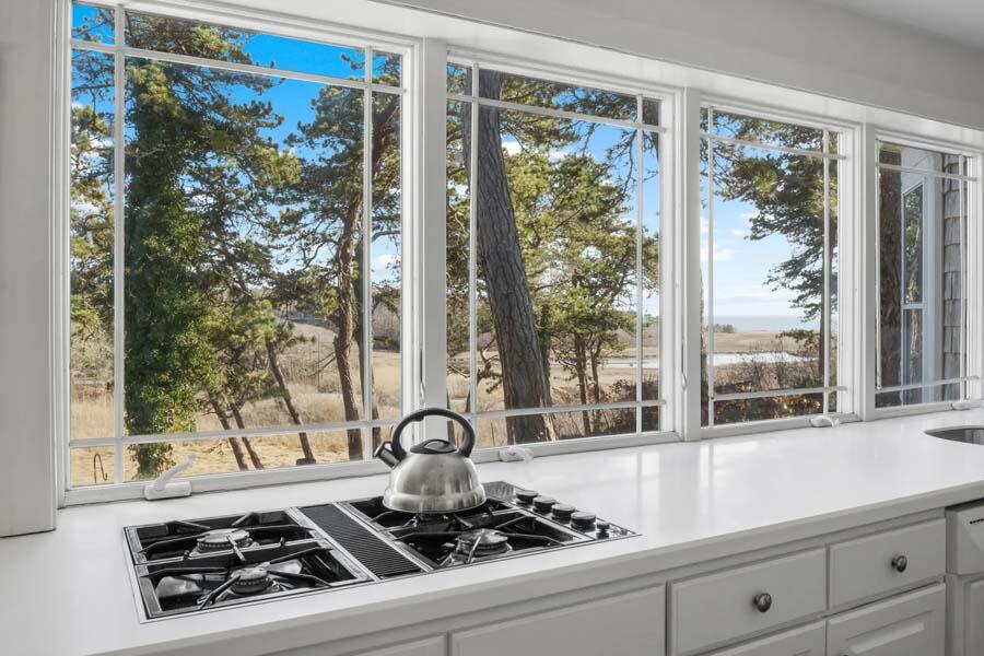17 Soundview Road Harwich, MA 02645 - Photo 11 of 37 a counter top with a stove a window and a glass door