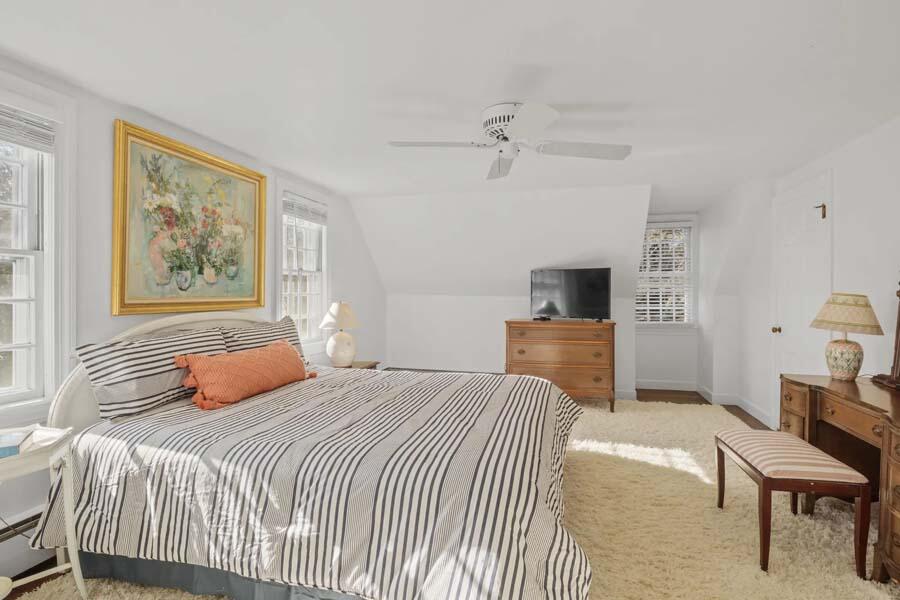 17 Soundview Road Harwich, MA 02645 - Photo 30 of 37 a bedroom with a bed a couch and a flat screen tv