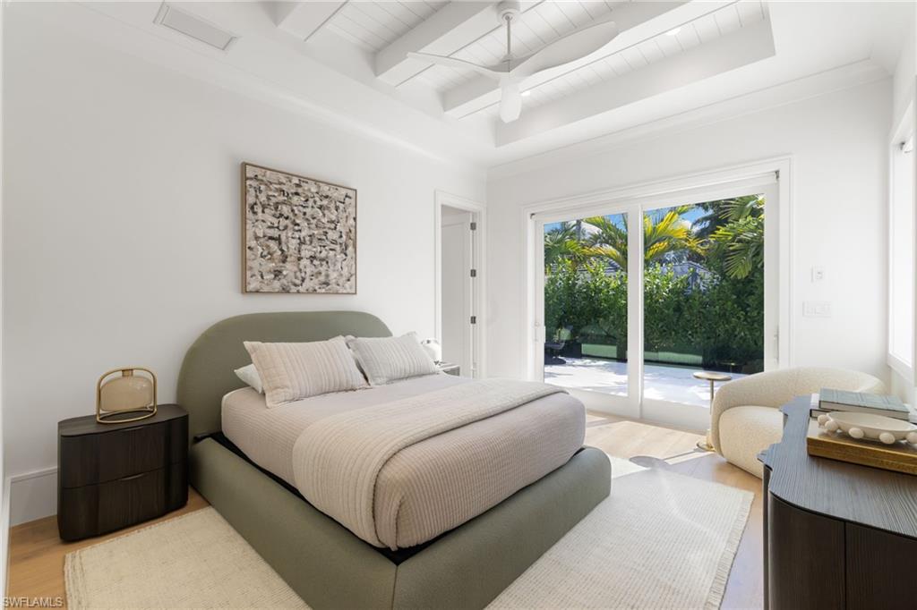 660 Wedge Drive Naples, FL 34103 - Photo 12 of 22 a bedroom with a bed and a large window