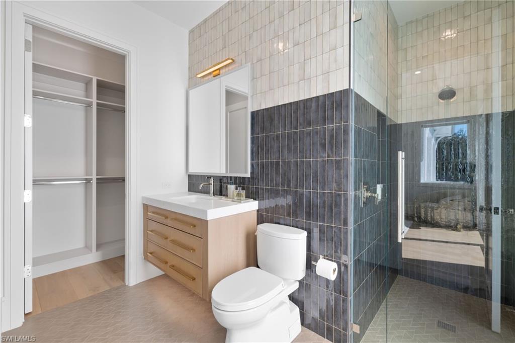 660 Wedge Drive Naples, FL 34103 - Photo 13 of 22 a bathroom with a toilet a sink and shower