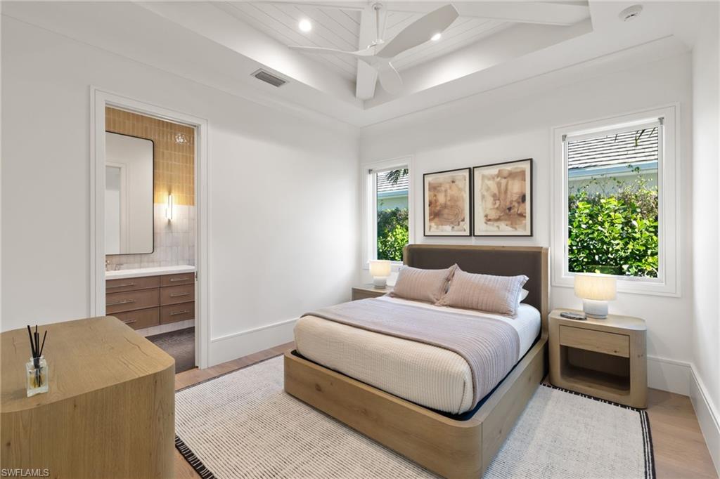 660 Wedge Drive Naples, FL 34103 - Photo 14 of 22 a bedroom with a large bed and a couch