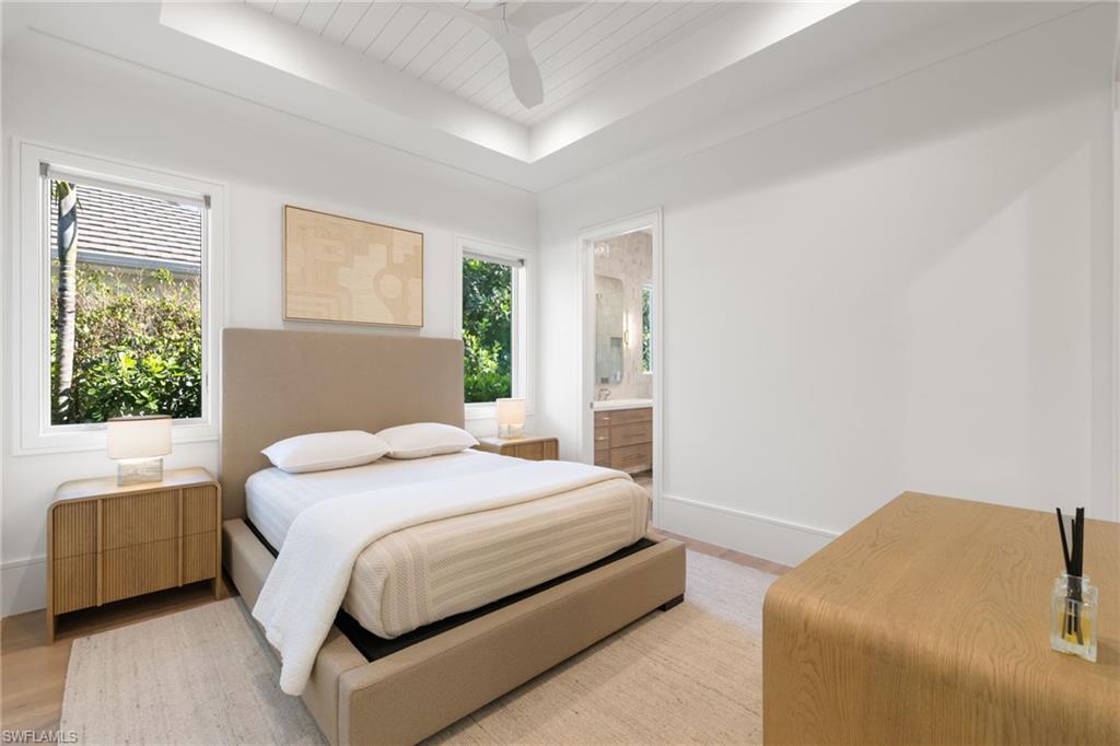 660 Wedge Drive Naples, FL 34103 - Photo 16 of 22 a bedroom with a bed and a couch