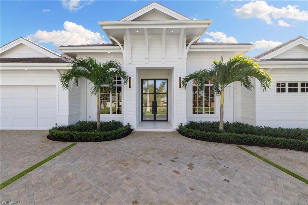 660 Wedge Drive Naples, FL 34103 - Photo 19 of 22 a front view of a house with garden