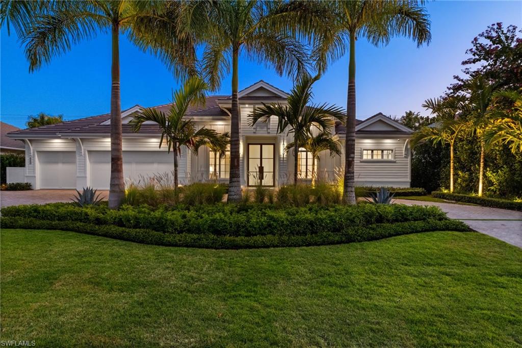 660 Wedge Drive Naples, FL 34103 - Photo 22 of 22 a front view of a house with garden and entryway