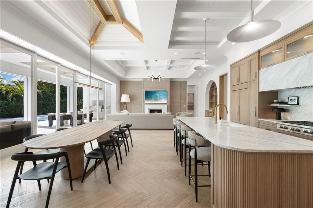 660 Wedge Drive Naples, FL 34103 - Photo 6 of 22 a view of a dining room with furniture window and wooden floor
