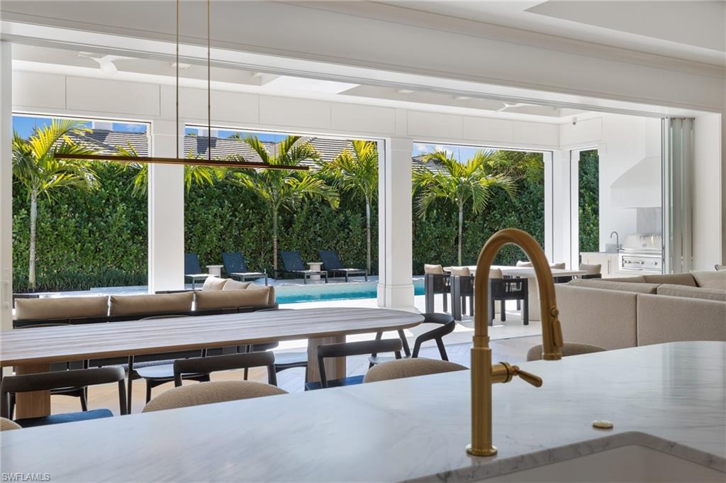 660 Wedge Drive Naples, FL 34103 - Photo 7 of 22 a room with furniture and large windows