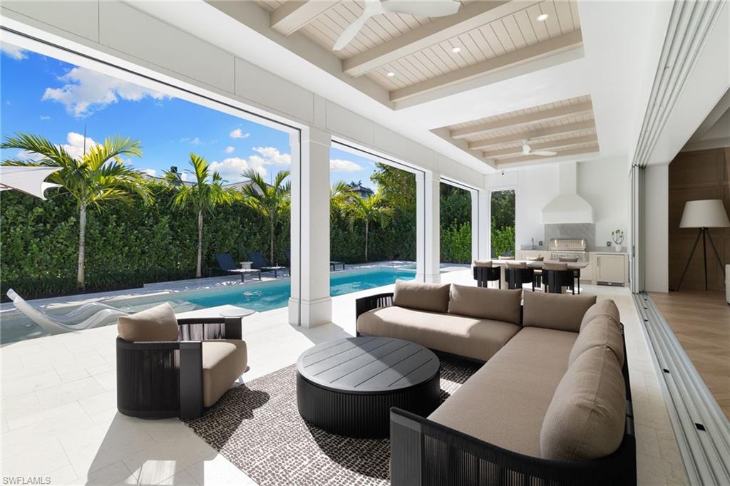 660 Wedge Drive Naples, FL 34103 - Photo 8 of 22 a living room with furniture and a large window