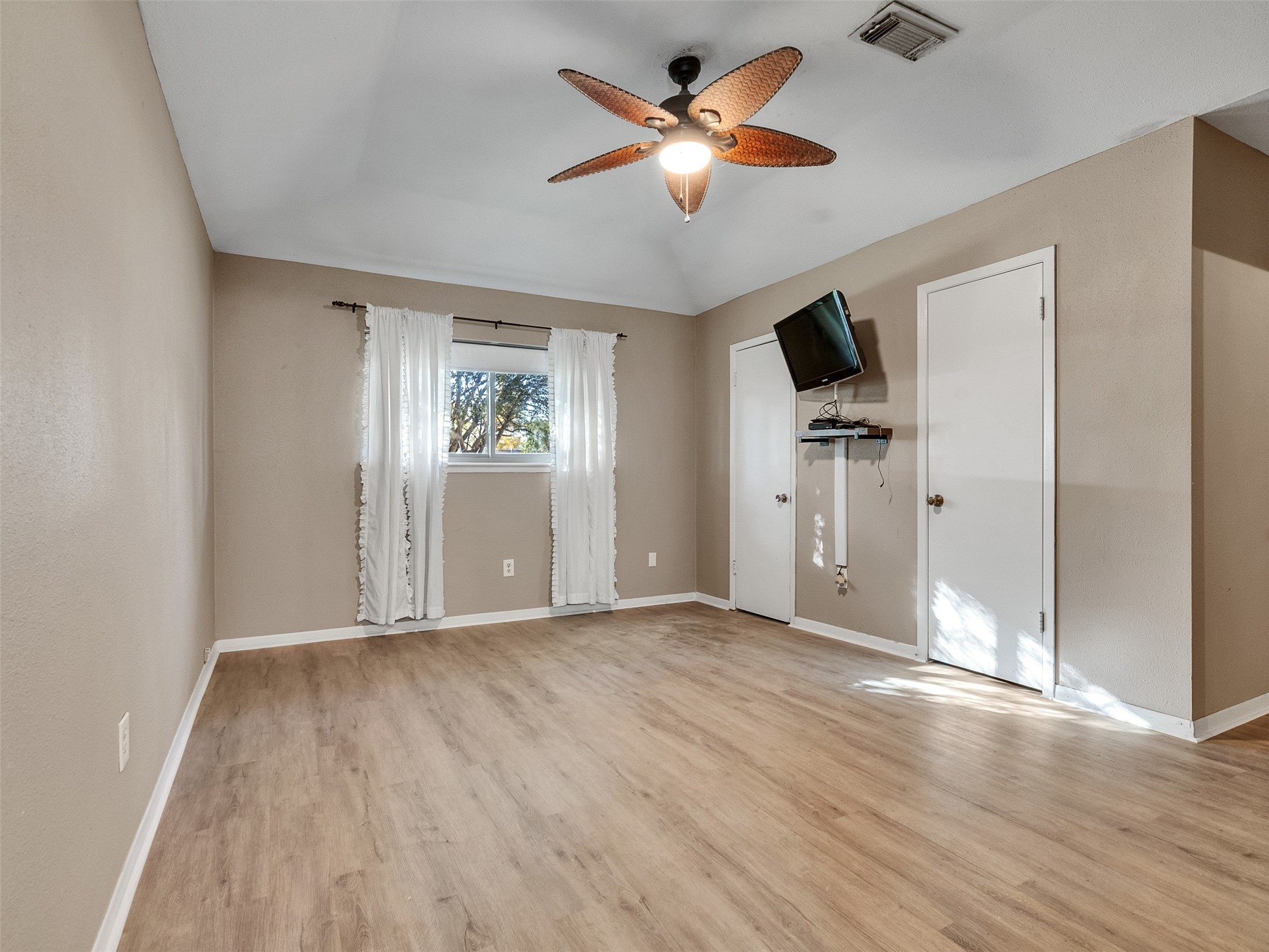 730 Broad Ripple Drive Houston, TX 77336 - Photo 19 of 28 an empty room with wooden floor chandelier fan and windows