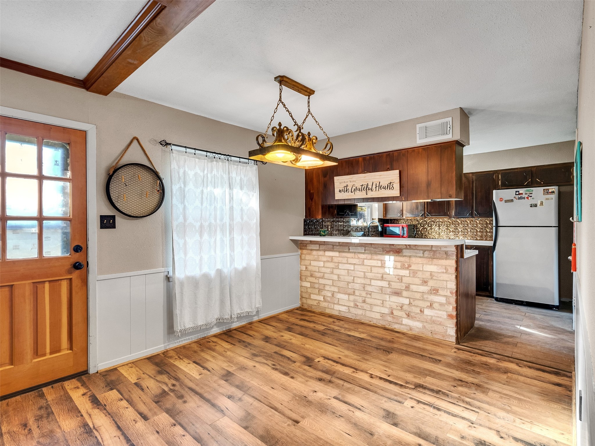 730 Broad Ripple Drive Houston, TX 77336 - Photo 9 of 28 a kitchen with stainless steel appliances granite countertop a refrigerator a oven and white cabinets with wooden floor