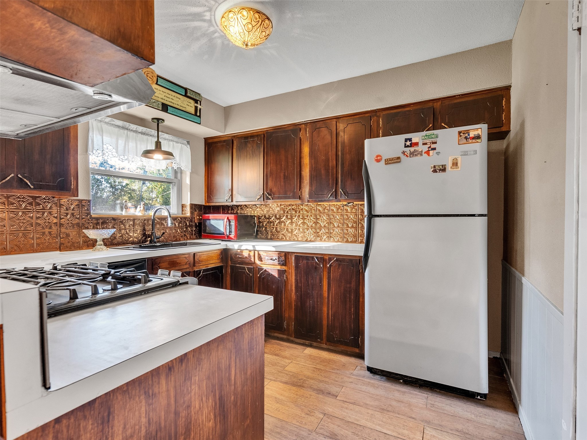 730 Broad Ripple Drive Houston, TX 77336 - Photo 10 of 28 a kitchen with a refrigerator and a stove