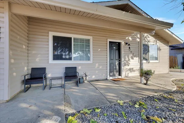 a front view of a house with a sitting area