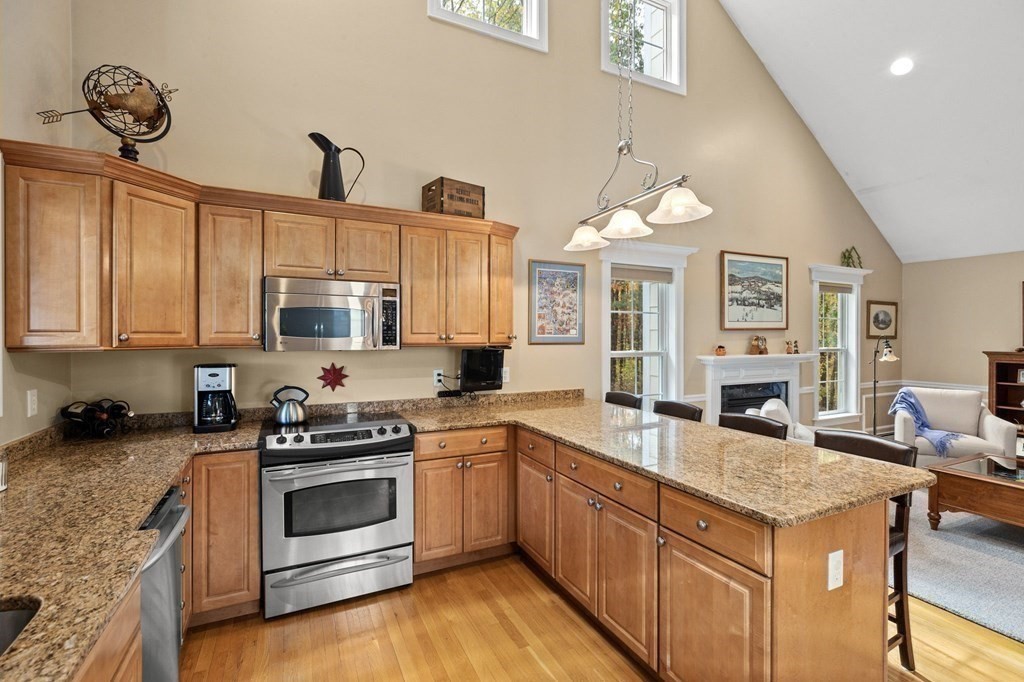 17 Summersweet Circle, Unit 22 Hanover, MA 02339 - Photo 11 of 42 a kitchen with stainless steel appliances granite countertop a stove a sink and a refrigerator
