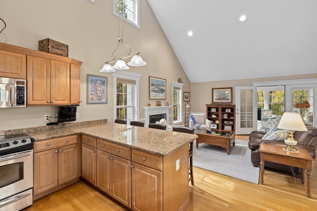 17 Summersweet Circle, Unit 22 Hanover, MA 02339 - Photo 12 of 42 a kitchen with sink stove and living room