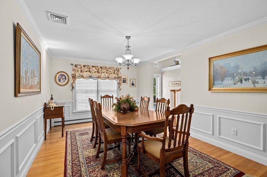 17 Summersweet Circle, Unit 22 Hanover, MA 02339 - Photo 15 of 42 a view of a dining room with furniture and chandelier
