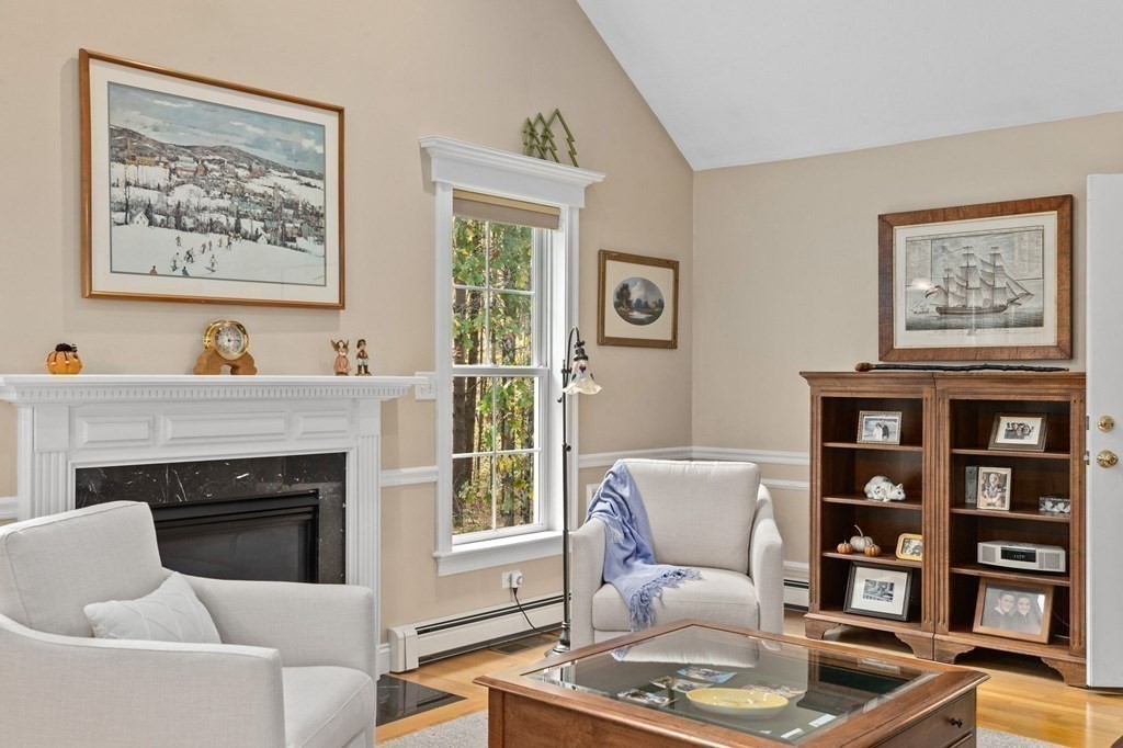 17 Summersweet Circle, Unit 22 Hanover, MA 02339 - Photo 17 of 42 a living room with furniture and a fireplace