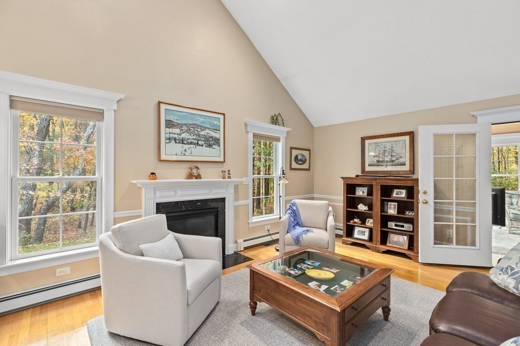 17 Summersweet Circle, Unit 22 Hanover, MA 02339 - Photo 18 of 42 a living room with furniture a fireplace and a large window