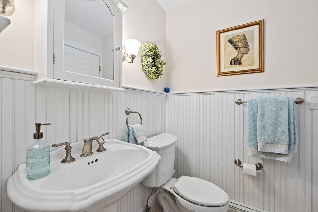17 Summersweet Circle, Unit 22 Hanover, MA 02339 - Photo 24 of 42 a bathroom with a toilet sink and mirror