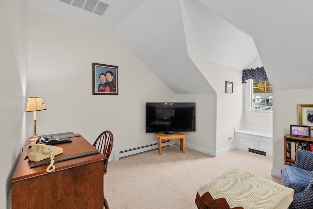 17 Summersweet Circle, Unit 22 Hanover, MA 02339 - Photo 32 of 42 a living room with furniture and a flat screen tv