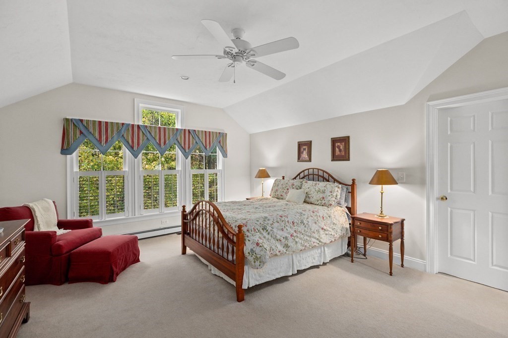 17 Summersweet Circle, Unit 22 Hanover, MA 02339 - Photo 34 of 42 a spacious bedroom with a bed and a chandelier