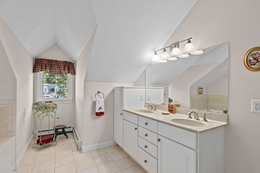 17 Summersweet Circle, Unit 22 Hanover, MA 02339 - Photo 38 of 42 a bathroom with a sink a mirror and a shower