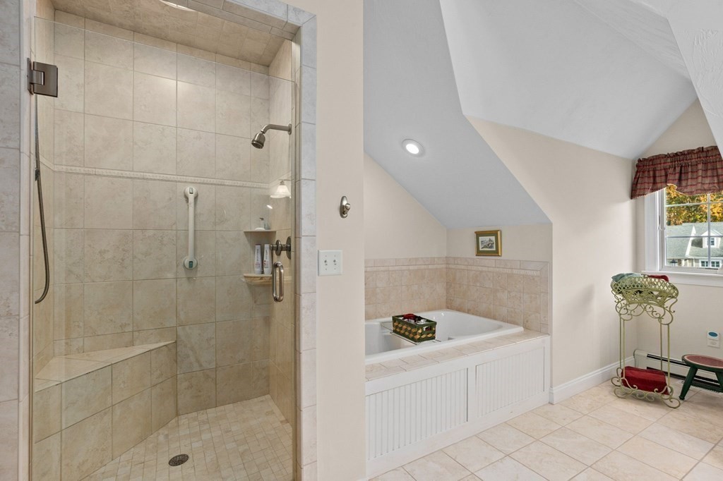 17 Summersweet Circle, Unit 22 Hanover, MA 02339 - Photo 39 of 42 a bathroom with a tub and a shower