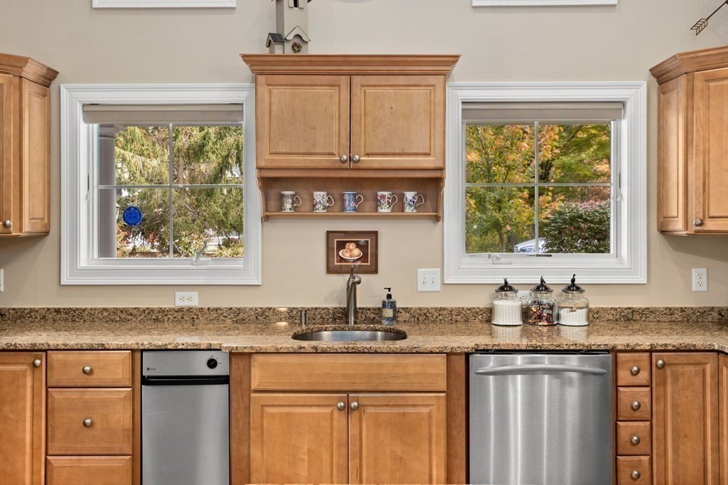 17 Summersweet Circle, Unit 22 Hanover, MA 02339 - Photo 9 of 42 a kitchen with stainless steel appliances granite countertop a stove a sink and a window