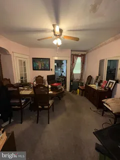 a room with furniture a flat screen tv and gym equipment