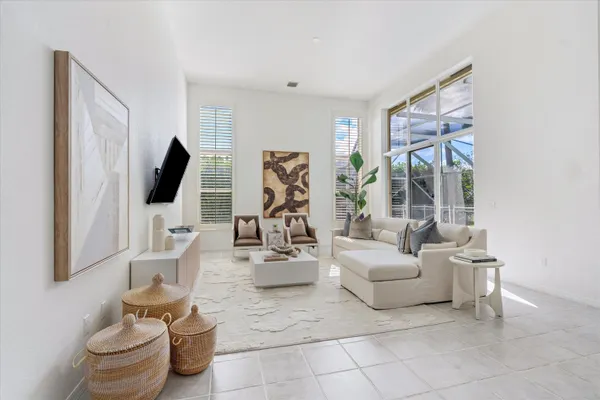 a living room with furniture a flat screen tv and a large window