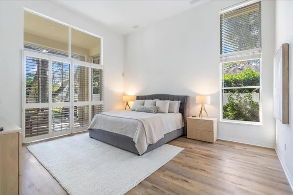 a bedroom with a large bed and a large window